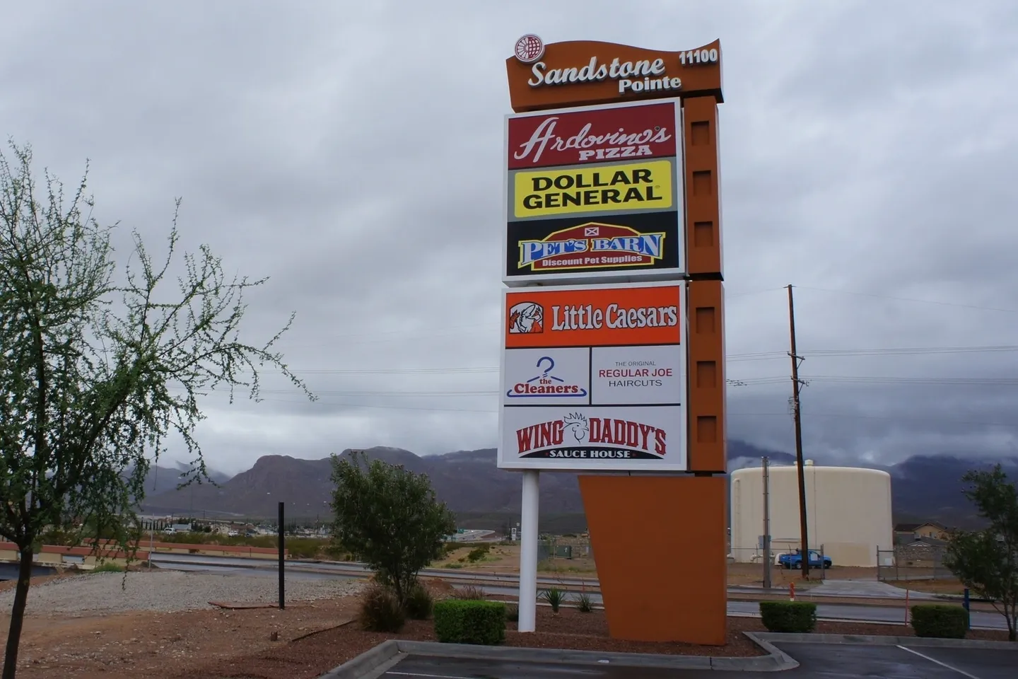 Retail plaza sign in cloudy weather.